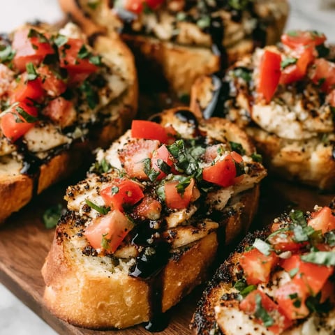 A plate of chicken bruschetta with tomatoes and basil.